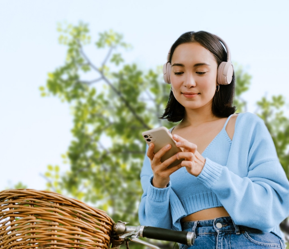 Young woman on bicycle checking smartphone