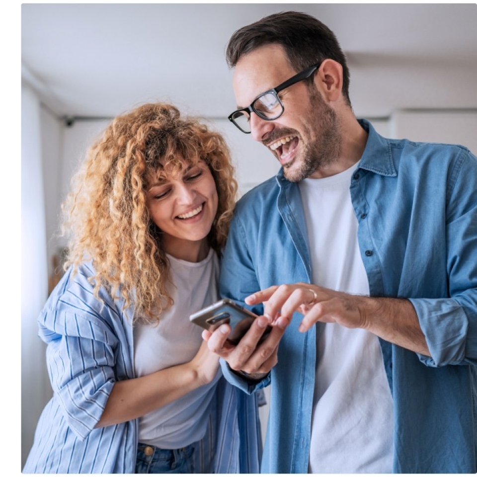 Couple looking at phone excited