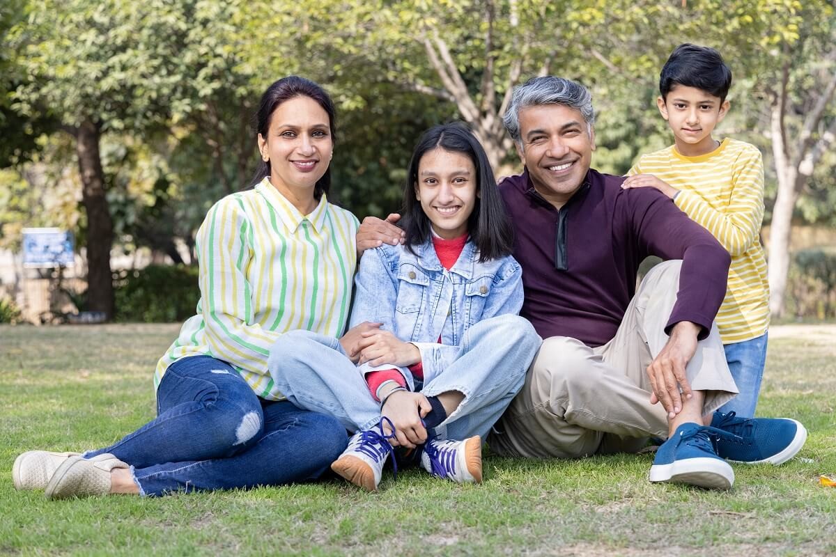 Portrait of happy Indian family spending leisure time at park
